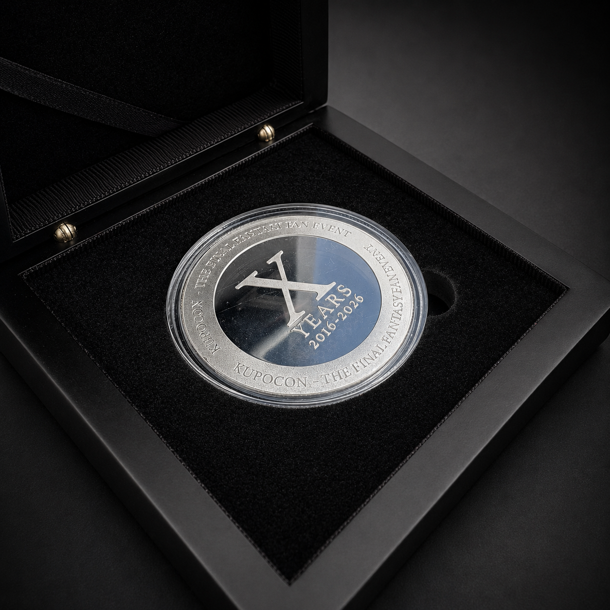 KupoCon 10 Year Anniversary commemorative silver-plated coin in a wooden display box with numbered collector's card