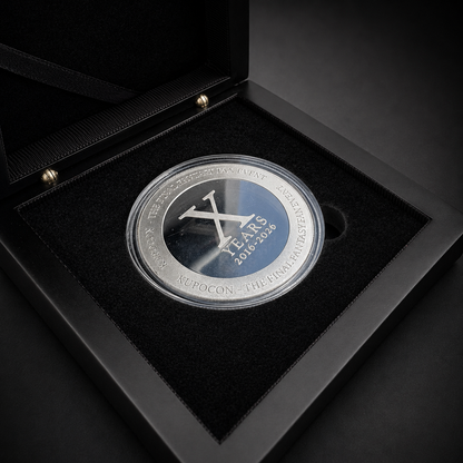 KupoCon 10 Year Anniversary commemorative silver-plated coin in a wooden display box with numbered collector's card